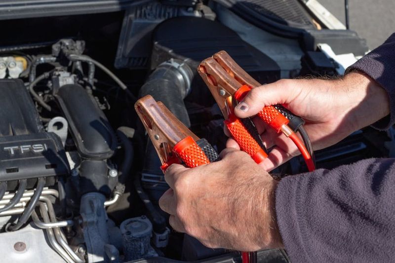Roadside assistance in Mesquite, TX: technician working under the hood of a stranded car
